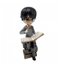Harry Potter figurine on a pile of Grimoires